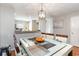 Bright dining area features modern light fixture and view into the kitchen at 1155 Harvester Circle # 1155, Myrtle Beach, SC 29579