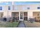 Charming exterior view of a two-story townhouse with a screened porch and well-maintained landscaping at 1155 Harvester Circle # 1155, Myrtle Beach, SC 29579