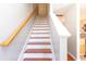 Staircase with wood treads, white risers, light-colored walls, and a wood handrail at 1155 Harvester Circle # 1155, Myrtle Beach, SC 29579