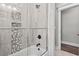 The bathroom featuring a tub and shower with stylish tile and glass door at 119 Sunset Dr., Murrells Inlet, SC 29576