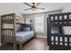 Bunk bedroom with a ceiling fan, a window with blinds, and a mix of wood and dark-colored bunk beds at 119 Sunset Dr., Murrells Inlet, SC 29576