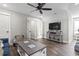 Cozy living room featuring hardwood floors, a ceiling fan, and a flat-screen TV mounted on a stylish console table at 119 Sunset Dr., Murrells Inlet, SC 29576