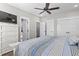 Bedroom showcasing a striped comforter, storage space and a TV mounted in the corner at 119 Sunset Dr., Murrells Inlet, SC 29576