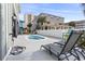 Inviting pool area with lounge chairs and a hot tub, set against a backdrop of neighboring buildings and clear skies at 119 Sunset Dr., Murrells Inlet, SC 29576