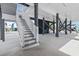 Underneath the house, featuring a staircase, support beams, and a concrete floor, providing ample space at 119 Sunset Dr., Murrells Inlet, SC 29576