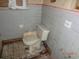 Dated bathroom shows an old toilet and dirty tiled walls at 12 E Sassafras St., Andrews, SC 29510