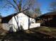 Outdoor shot showing the side of a home next to a tree with shadows at 12 E Sassafras St., Andrews, SC 29510