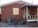 Outdoor shot of the side of a brick house showing a covered porch at 12 E Sassafras St., Andrews, SC 29510