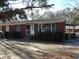 Charming brick home with a well-maintained front yard and covered porch at 12 E Sassafras St., Andrews, SC 29510