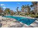 Community pool surrounded by lounge chairs and lush landscaping for relaxation at 1221 Tidewater Dr. # 321, North Myrtle Beach, SC 29582