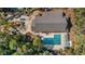 Aerial view of a community building with a pool and sun deck surrounded by mature trees and greenery at 1221 Tidewater Dr. # 321, North Myrtle Beach, SC 29582