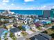 Aerial view of colorful houses near the beach with blue ocean water and surrounding commercial buildings at 128 Seabreeze Dr., Murrells Inlet, SC 29576