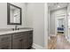 Bathroom featuring a gray vanity with granite countertop, modern fixtures, and gray walls at 128 Seabreeze Dr., Murrells Inlet, SC 29576