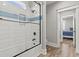 Bathroom with a shower-over-tub with a glass door, white subway tile, and a blue accent stripe at 128 Seabreeze Dr., Murrells Inlet, SC 29576