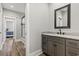 Bathroom with a gray vanity, granite countertop, black hardware, and a view into the shower room at 128 Seabreeze Dr., Murrells Inlet, SC 29576