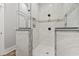 Modern bathroom showcasing a stylish shower with white tile and built-in shelving niches at 128 Seabreeze Dr., Murrells Inlet, SC 29576