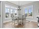 Dining room with stylish chairs, wood flooring, a modern chandelier, and abundant natural light at 128 Seabreeze Dr., Murrells Inlet, SC 29576