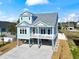 Inviting two-story home with light blue siding, white railings, and elevated design for beachside living at 128 Seabreeze Dr., Murrells Inlet, SC 29576