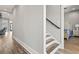 Hallway with a view of stairs, wooden floors and trim, and a view into the main bedroom at 128 Seabreeze Dr., Murrells Inlet, SC 29576