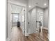 Bright hallway with wood floors and white doors leading to various rooms at 128 Seabreeze Dr., Murrells Inlet, SC 29576