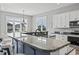 Modern kitchen island with elegant countertops, seating and stainless steel appliances in the background at 128 Seabreeze Dr., Murrells Inlet, SC 29576