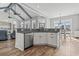 Modern kitchen leading to the dining area, featuring granite counters, an island, and stainless steel appliances at 128 Seabreeze Dr., Murrells Inlet, SC 29576