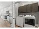 Laundry room with full size washer and dryer hookup, with grey storage and access to kitchen at 128 Seabreeze Dr., Murrells Inlet, SC 29576