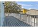 Open porch with views, grey wood deck, and white railings to the backyard at 128 Seabreeze Dr., Murrells Inlet, SC 29576