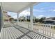 Spacious covered porch with white railings and a view of nearby buildings and trees at 128 Seabreeze Dr., Murrells Inlet, SC 29576