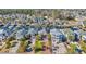 Aerial view of a waterfront neighborhood with well-manicured lawns, lush trees, and boats docked in backyard at 128 Waterway Crossing Ct., Little River, SC 29566