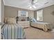 Charming bedroom features two twin beds, dresser and ceiling fan at 128 Waterway Crossing Ct., Little River, SC 29566