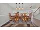 Formal dining room with a wooden table, eight chairs, decorative rug, and modern light fixtures at 128 Waterway Crossing Ct., Little River, SC 29566