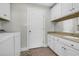 Well-equipped laundry room with washer, dryer, sink, and plenty of storage at 128 Waterway Crossing Ct., Little River, SC 29566