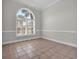 Bright room showcasing tile flooring, large window, and neutral color palette at 128 Waterway Crossing Ct., Little River, SC 29566