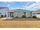 Backyard with a screened-in porch, well-maintained lawn, and stylish exterior of a single-Gathering home at 1317 Captain Hooks Way, North Myrtle Beach, SC 29582