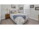 Cozy bedroom featuring a queen-size bed with brass accents and bright natural light from the window at 1317 Captain Hooks Way, North Myrtle Beach, SC 29582