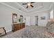 Comfortable main bedroom with tray ceilings, ceiling fan, and warm decor at 1317 Captain Hooks Way, North Myrtle Beach, SC 29582