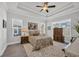 Spacious main bedroom features tray ceilings, ample natural light, and modern ceiling fan at 1317 Captain Hooks Way, North Myrtle Beach, SC 29582