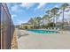 Community pool area with lounge chairs and shaded cabana for residents' enjoyment and relaxation at 1317 Captain Hooks Way, North Myrtle Beach, SC 29582