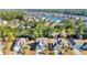 Beautiful aerial view of the community showcasing homes, a pond with fountain, and mature trees at 132 Summerlight Dr., Murrells Inlet, SC 29576