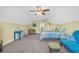 A bright bedroom featuring a vaulted ceiling, ceiling fan, desk, bed, sitting area, and a side table at 132 Summerlight Dr., Murrells Inlet, SC 29576