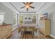 Well-lit bedroom featuring a ceiling fan and two windows, with stylish furniture at 132 Summerlight Dr., Murrells Inlet, SC 29576