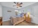 A cozy bedroom features a ceiling fan, window with curtains, and a nightstand with a lamp for reading at 132 Summerlight Dr., Murrells Inlet, SC 29576