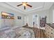 Bright bedroom with a ceiling fan, dresser, and an adjacent bathroom at 132 Summerlight Dr., Murrells Inlet, SC 29576