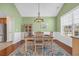 Light-filled dining room featuring a stylish chandelier, wainscoting, and a decorative rug at 132 Summerlight Dr., Murrells Inlet, SC 29576