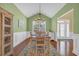 Dining room with green walls, white wainscoting, a chandelier, and a light-filled atmosphere at 132 Summerlight Dr., Murrells Inlet, SC 29576