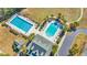 Overhead shot of the community pools and clubhouse, surrounded by palm trees and lounge chairs at 132 Summerlight Dr., Murrells Inlet, SC 29576