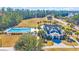 Overhead view of the community clubhouse and large pool, with surrounding palm trees and landscaping at 132 Summerlight Dr., Murrells Inlet, SC 29576