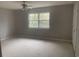 Bright bedroom with a large window offering natural light and neutral carpeting at 1413 Cane St. # 1, North Myrtle Beach, SC 29582