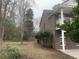 Side view of a brick house showcasing the outdoor space and architectural details, set against a natural backdrop at 1413 Cane St. # 1, North Myrtle Beach, SC 29582